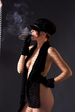 woman in black astrakhan smoking cigar