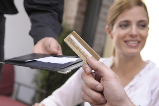 Man Paying A Bill  In A Restaurant