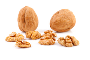 pieces and whole walnut over white background