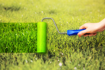Young woman painting on grass