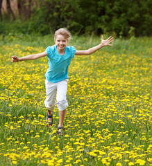 Happy child  running in  field. Outdoor.