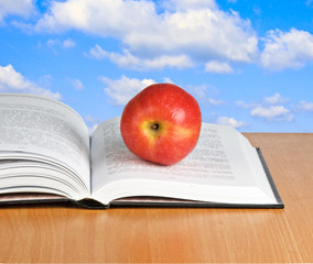 Red apple on  open book