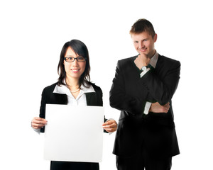 Smiling businesswoman and businessman with blank sign