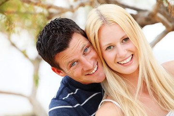 Fototapeta premium Young happy couple. Shallow DoF with focus on the woman.