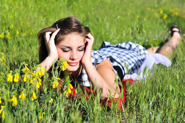 teen girl laying on the meadow