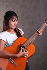 Thai girl playing guitar