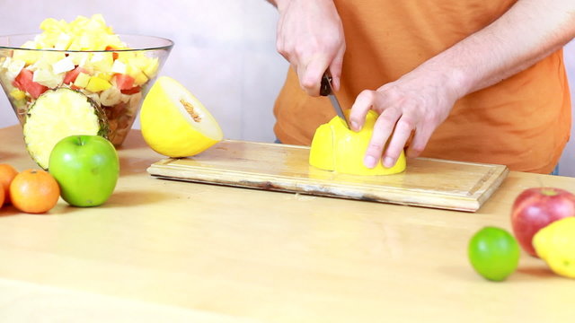 Slicing melon - Preparing fruit salad close-up