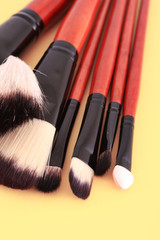 Cosmetic brushes on orange background