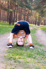 Boy stands in a funny position