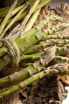 raw asparagus on wood background