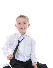 Happy little boy sitting on the floor.