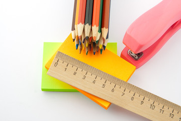 colored pencils and stickers on white background