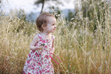 Adorable toddler girl in a floral dress