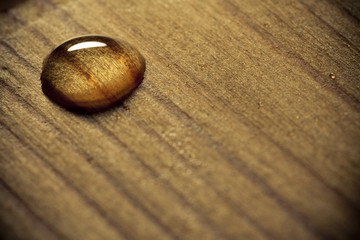 Waterdrop on a wooden surface.
