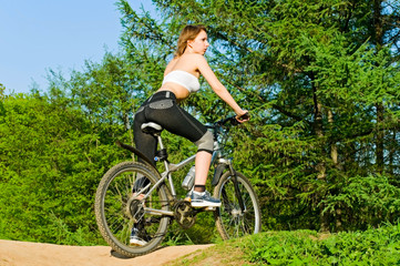 Fototapeta na wymiar young woman on bicycle