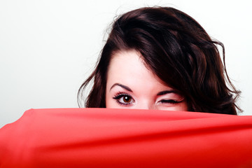 closeup picture of girl hiding behind the cloth