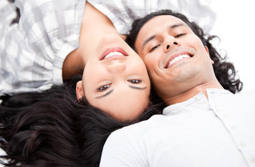 Laughing couple relaxing on the floor