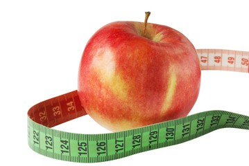 Diet concept. Apple with measure tape isolated