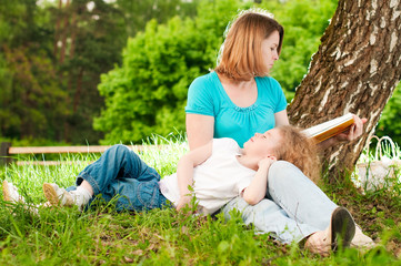 mother reading book to her daughter