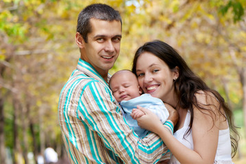 Fototapeta premium family with baby in in autumn park