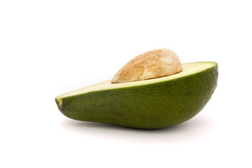 half an avocado with stone isolated on white