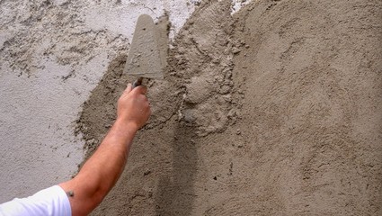 Plastering a wall outside