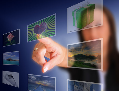 Woman hand reaching images on the screen