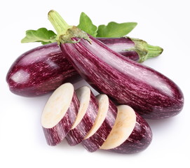 Purple eggplants with leaves on white background