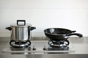 A stainless steel pot on a gas stove
