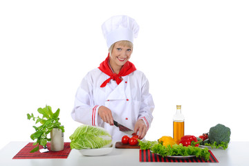 young girl cuts tomatoes.