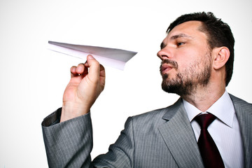 Mature business man throwing a paper plane