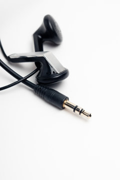 closeup of audio mini jack plug with out of focus earphones