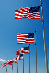 US flags flapping in wind, Washington Monument