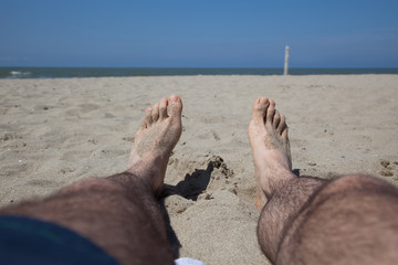 male foot on the sand