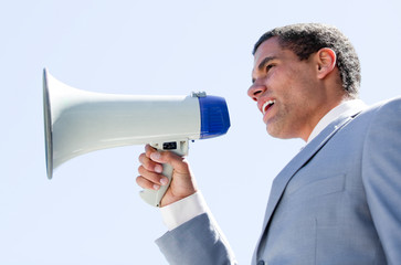 Charismatic businessman yelling through a megaphone