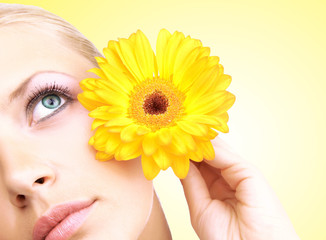 Beautiful young woman with gerber flower isolated