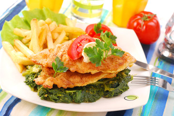 fish on spinach with fries