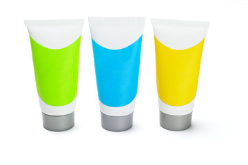Three colorful cosmetic tubes