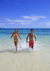 young couple comes out of the ocean