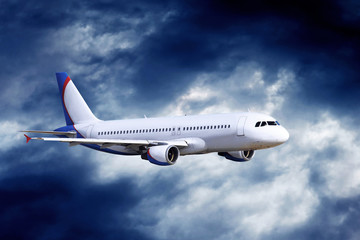 Airplane at fly on the sky with clouds