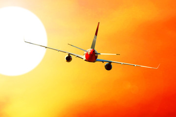 Airplane at fly on the sky with clouds