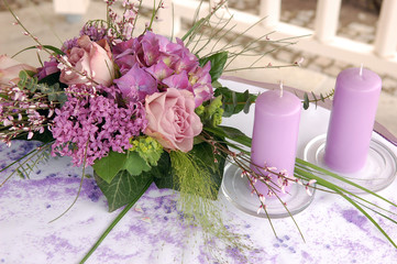 Violet wedding decoration with flowers and candles
