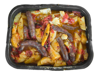 Sausages and potatoes in nonstick baking-pan.