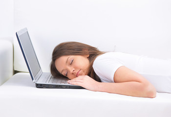 Young business woman sleeping on sofa, laptop resting