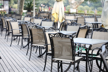 empty tables in street cafe .
