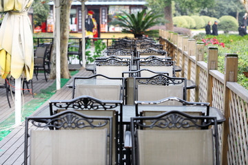empty tables in street cafe .
