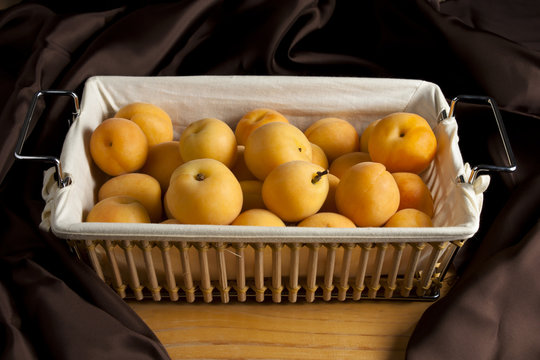 Apricots in a Basket with Brown Satin
