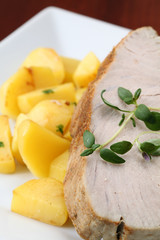 Roast tuna steak with potatoes and thyme