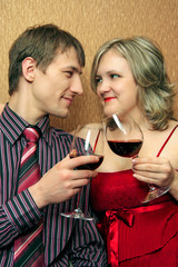 young pair clink glasses with