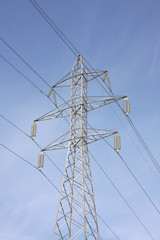 High voltage electricity pylon against blue sky